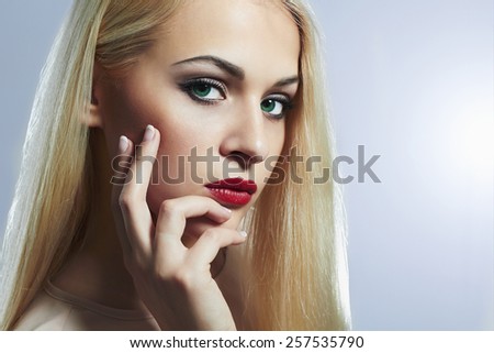 Blond woman with manicure.Beautiful girl model with make-up. red lips