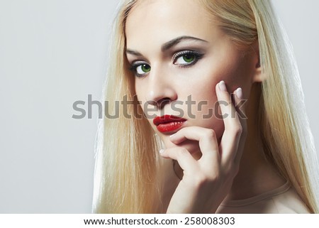 Blond woman with manicure.Beautiful girl model with make-up. red lips