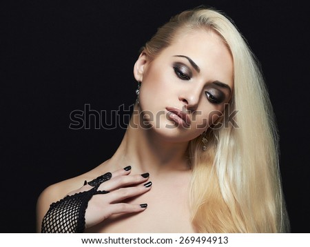 Beautiful Fashion Girl Portrait over black background. sexy Blond Girl Wearing Gloves. Glamor Make-up
