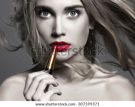 monochrome girl with red lips.beautiful girl Applying lipstick. young Woman putting red lipstick