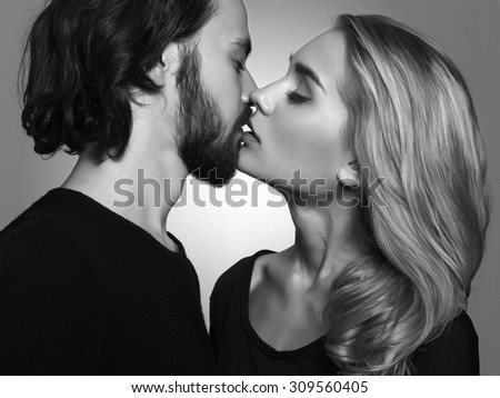 Kissing couple.romantic beautiful woman and handsome man.monochrome portrait of lovely boy and girl
