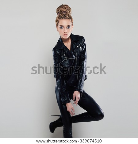 sexy beautiful girl in leather.punk rock blond young woman in latex and high heels.dreadlocks hairstyle
