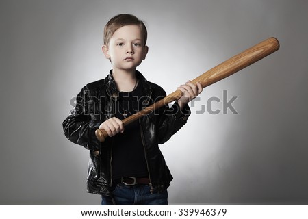 little Hooligan with baseball bat.thug boy.Funny child in leather coat