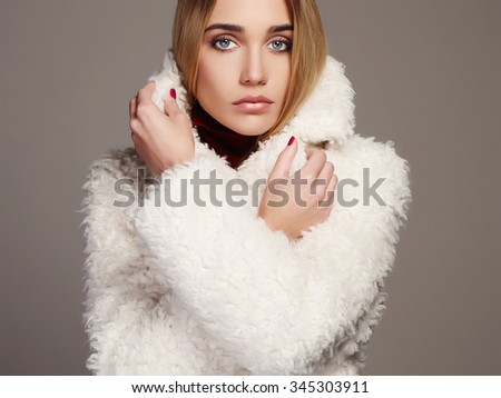 Gorgeous young woman in winter fashion wearing a fur.beautiful blond hair model girl