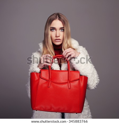 Winter beautiful Woman with red Handbag. Beauty Fashion Model Girl in fur. luxury stylish blonde. Shopping