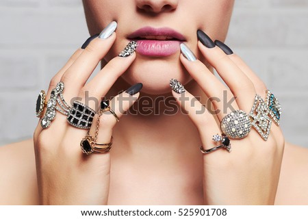 woman\'s hands with jewelry rings.close-up beauty and fashion portrait. girl make-up and manicure