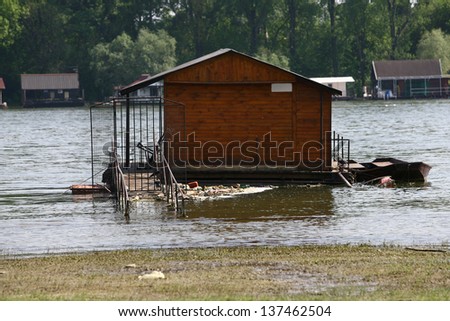 houses on the water, and trash around by the flood