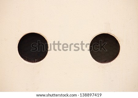 yellow wall with black holes