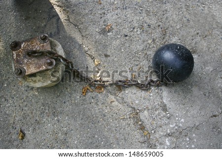 iron ball with chain and shackle related to stone pillar