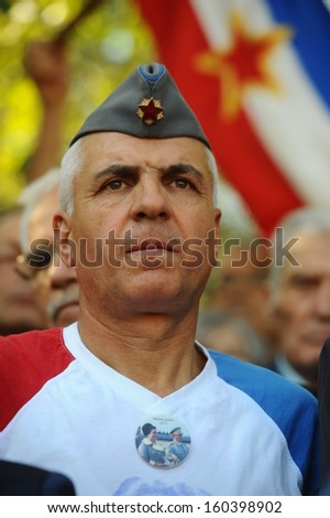 Belgrade, Serbia - October 26, 2013: A man with symbols and flag of Yugoslavia at the funeral of Jovanka Broz. Jovanka Broz, Yugoslavia\'s former First Lady built by her husband Josip Broz Tito in the House of Flowers mausoleum.