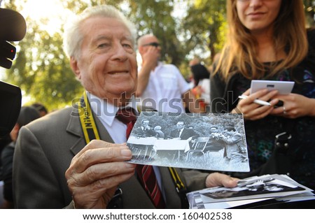 Belgrade, Serbia - October 26, 2013: A man shows pictures of Tito at the funeral of Jovanka Broz. Jovanka Broz, Yugoslavia\'s former First Lady built by her husband Josip Broz Tito in the House of Flowers mausoleum.