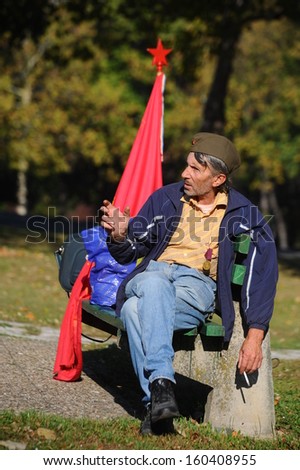Belgrade, Serbia - October 26, 2013: Man with flag of Yugoslavia at the funeral of Jovanka Broz. Jovanka Broz, Yugoslavia\'s former First Lady built by her husband Josip Broz Tito in the House of Flowers mausoleum.