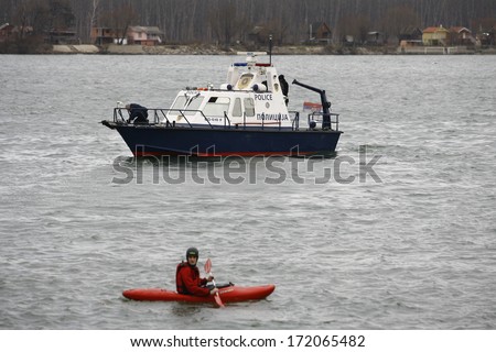 ZEMUN, SERBIA - JAN 19, 2014: Serbian river police on duty. The Serbian Orthodox Church, traditionally marks Epiphany with competitions to retrieve the Holy Cross from Danube river in Zemun quay.