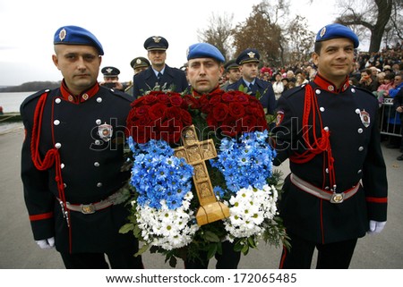 ZEMUN, SERBIA - JAN 19, 2014: Members of the police carry Holy Cross. The Serbian Orthodox Church, traditionally Epiphany with competitions to retrieve the Holy Cross from Danube river in Zemun.