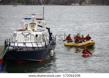 ZEMUN, SERBIA - JAN 19, 2014: Serbian river police on duty. The Serbian Orthodox Church, traditionally marks Epiphany with competitions to retrieve the Holy Cross from Danube river in Zemun quay.