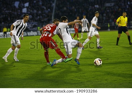 SERBIA, BELGRADE - APRIL 27, 2014: Kovacevic attack from behind Brnovic. Eternal rivals have met 146th times in the Eternal soccer derby, FC Partizan and Red Star from Belgrade, was played on 27 April