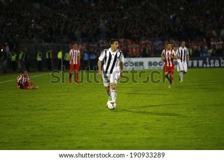 SERBIA, BELGRADE - APRIL 27, 2014: Mane Bajic in attackin game, Eternal rivals have met 146th times in the Eternal soccer derby, Partizan and Red Star from Belgrade, was played on 27 April in Belgrade