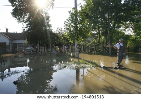 SERBIA, OBRENOVAC - MAY 21: A man standing in water in Obrenovac under water. The water level of Sava River remains high in worst flooding on record across the Balkans on may 21, 2014