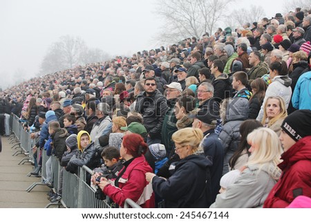 BELGRADE, SERBIA - JAN 19, 2015: Believers and the audience during the ceremony. Orthodox Christians celebrate Epiphany with traditional ice swimming in Belgrade.