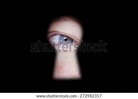 eye looking and spying at you through door keyhole