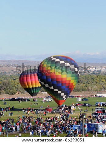 ALBUQUERQUE, NM - OCTOBER 8: Crowds cheer hot air balloon flight crews during the annual International Balloon Fiesta in Albuquerque, NM on October 8, 2011