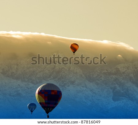 Colorful hot air balloon over a mountain top at dawn