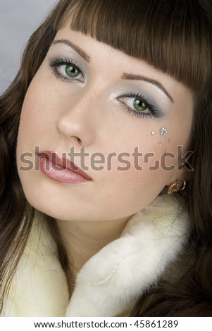 Attractive woman with beautiful makeup in white fur