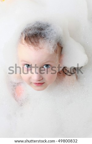 Adorable little girl in bath foam