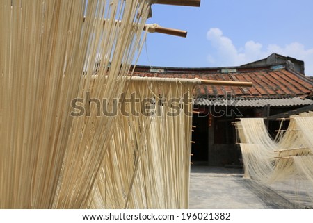 Traditional handmade long string noodles dry under the sunlight in Taiwan