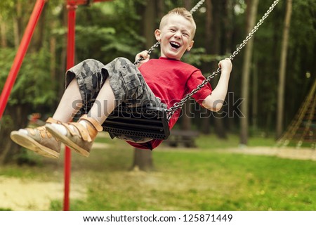Little boy swinging