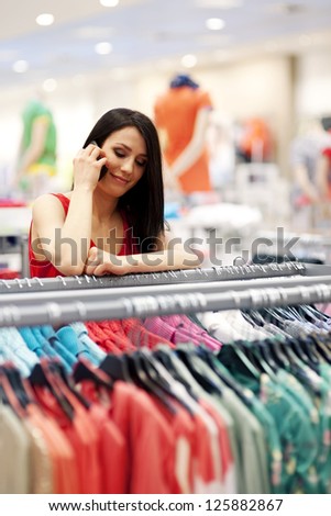 Young woman talking on mobile phone in store