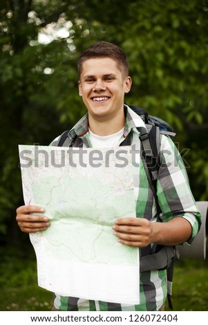 Man holding a map in forest
