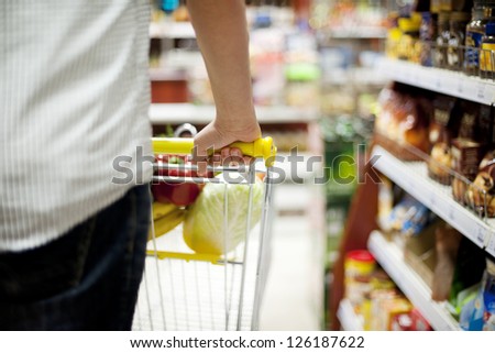 Man pushing shopping trolley
