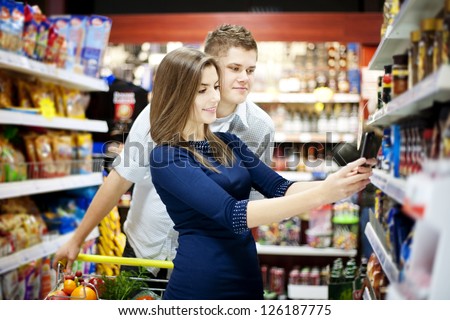 Young Couple Shopping At Supermarket