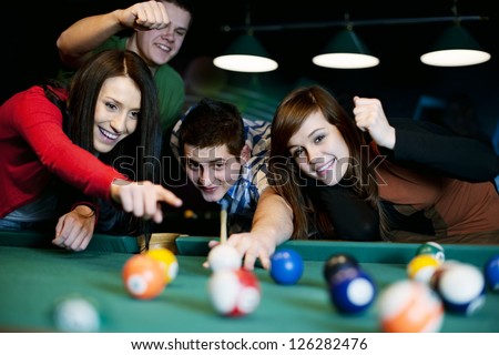 Friends playing billiard