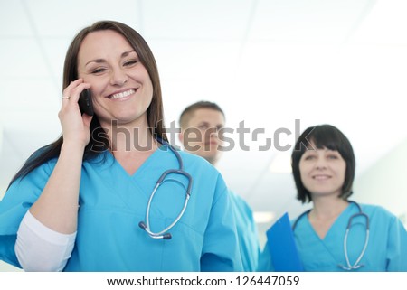 Female surgeon talking on mobile phone
