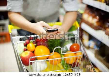 Man reading a text message during shopping