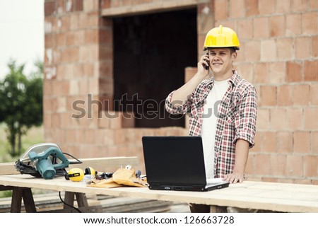 Carpenter talking on mobile phone