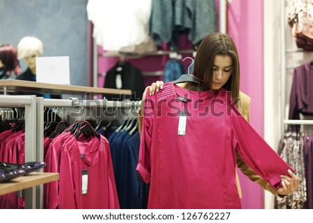 Beautiful young woman shopping in a clothing store