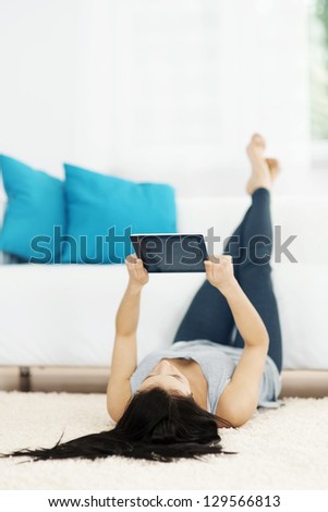 Young Woman Using Tablet On The Floor
