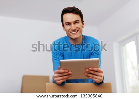 Happy man organize relocation in his new apartment