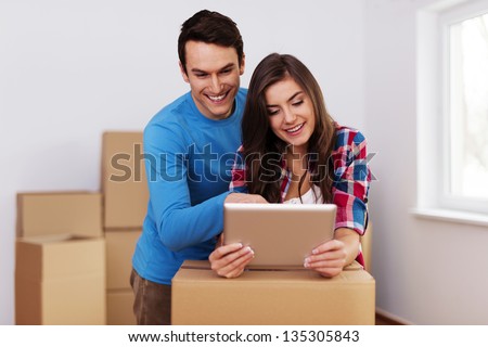 Young and loving couple arranging relocation in new home