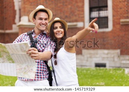 Woman Pointing At Something To Her Boyfriend During Sightseeing