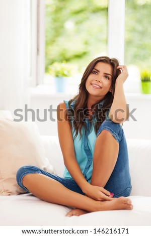 Woman day dreaming in living room