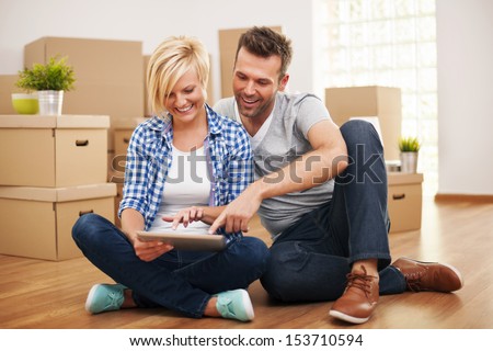 Smiling Couple Buying New Furniture For Their Home