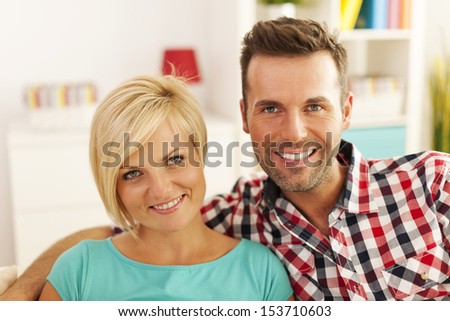 Portrait of smiling couple in living room