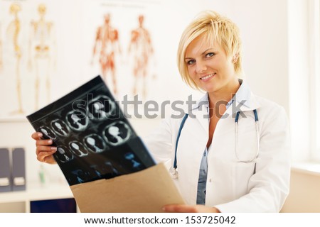 Young female doctor opening envelope with brain tomography result