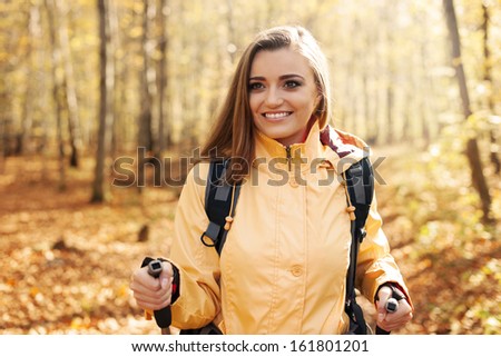 Active beautiful woman hiking in autumn