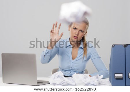 Tired woman throwing out office documents