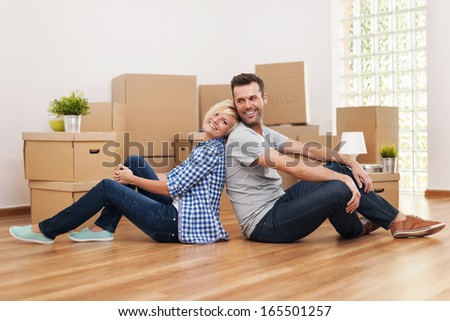 Loving couple sitting in their new apartment